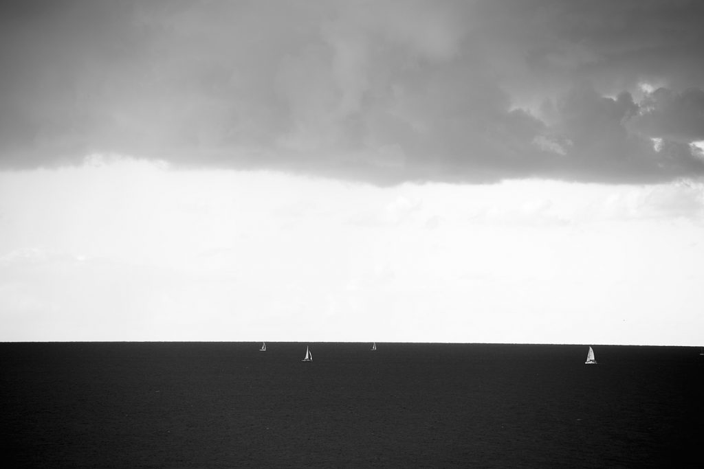 Sunset three layers sailboats